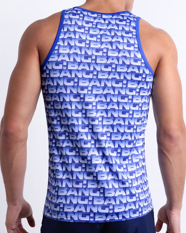 Back view of a male model wearing men’s ESCAPADE (BLUE/WHITE) beach Show Shorts swimsuit in a blue and white monogram design made by BANG! Clothes in Miami. This tank top is perfect for any activity, such as working out or CrossFit.