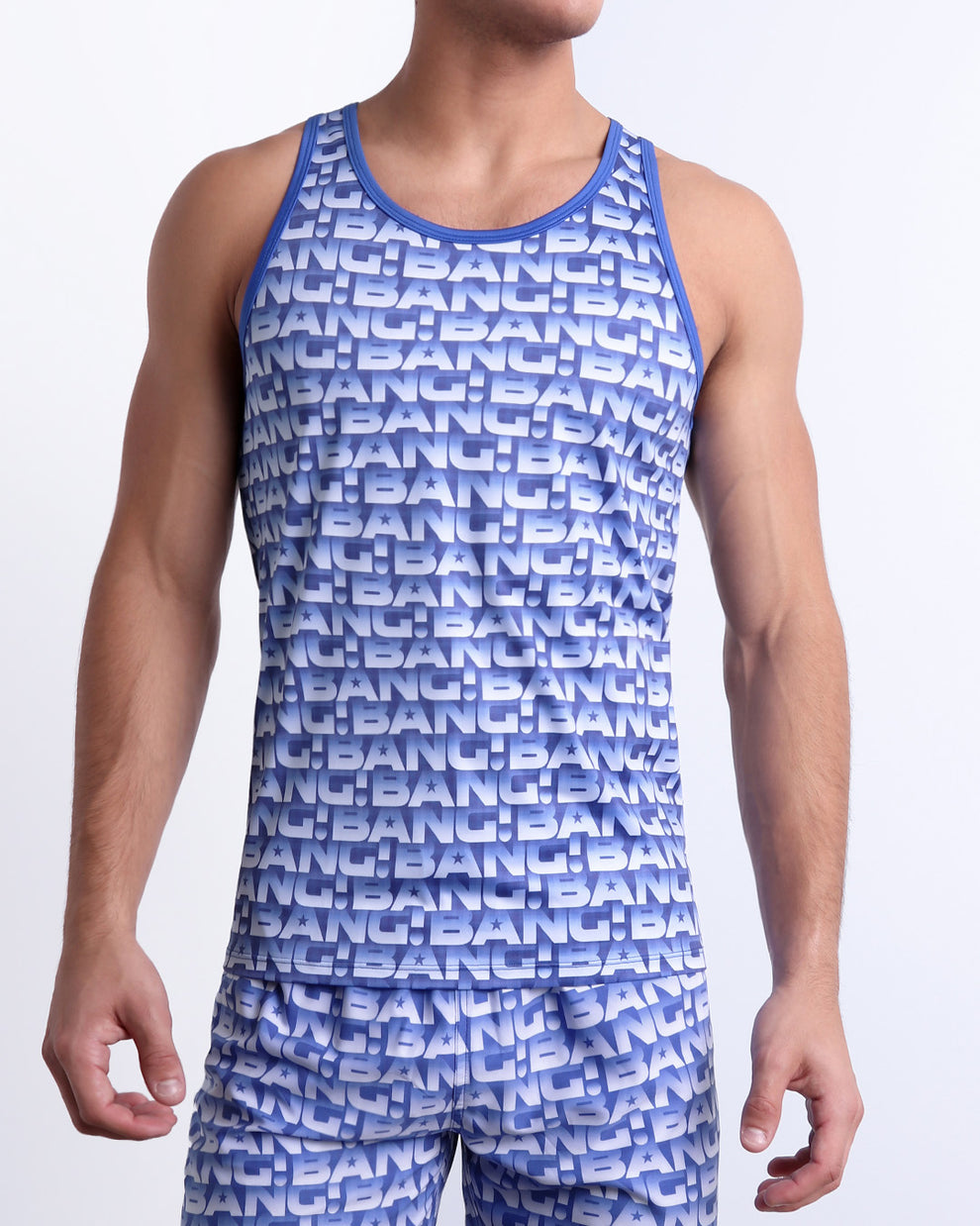 Male model wearing ESCAPADE (BLUE/WHITE) beach Tank Top, premium swimwear with a stylish blue and white graphic monogram print for men. This high-quality Summer top by BANG! Clothes, a men’s beachwear brand from Miami.