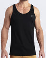 Frontal view of male model wearing the EXACT BLACK in a solid dark black color casual gym tank top for men by the DC2 brand of men's beachwear from Miami.