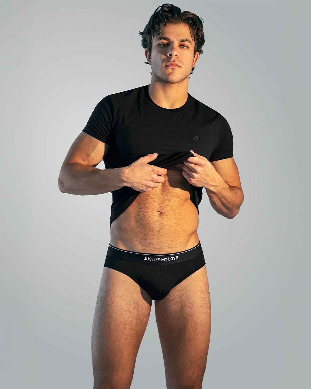 Model wearing DC2 Justify My Love Modal Briefs paired with the Exact Black Modal Cotton T-Shirt, featuring a sleek monochrome look and signature elastic waistband.