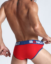 Back view of model wearing the FANTASY from the Sport line Men’s breathable cotton briefs in a blue and red color for men by BANG! Offers light compression for perfect contouring to the body and second-skin fit.