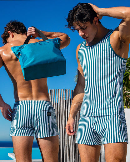 DC2 Fast Lines Pacific Green Series — models wearing the matching striped Poolside Shorts and Tank Top, featuring vertical green-and-white stripes crafted from quick-dry fabric for a coordinated resort-ready look.
