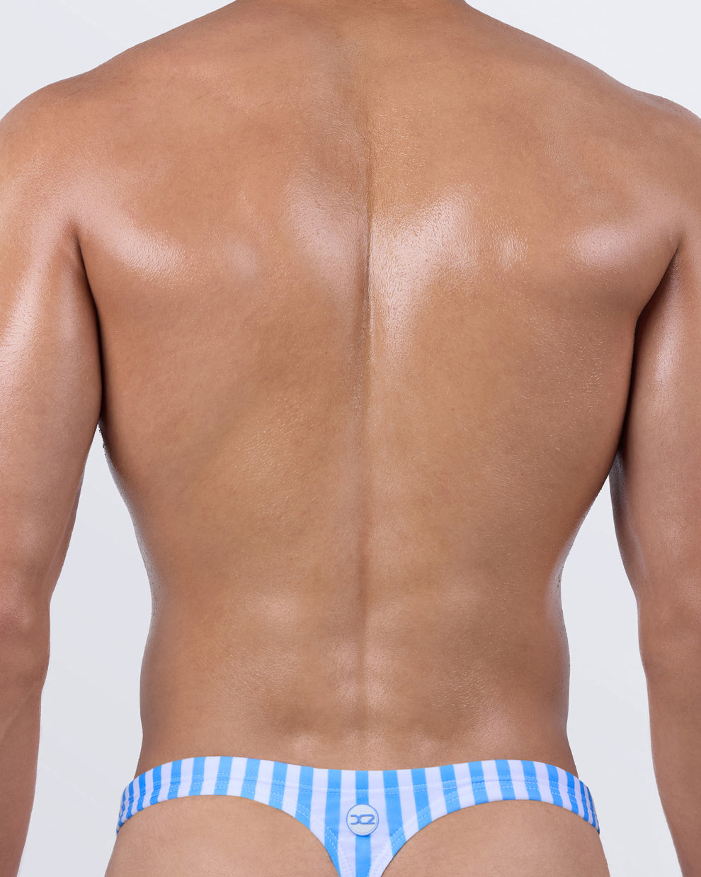Back view of men’s swim thong in FAST LINES (SKY BLUE) by DC2 BANG! – classic T-back shape with ultra-minimal rear coverage, ideal for sunbathing and showing off physique.
