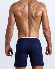Back view of the men's above-knees length fitness workout shorts in a solid dark navy blue color by BANG! menswear Miami.