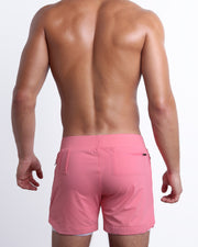Back view of the FLAMINGO PINK men's fitness compression lined workout shorts in a pink rose color. These premium quality quick-dry endurance shorts are DC2 by BANG! Clothes, a men’s beachwear brand from Miami.