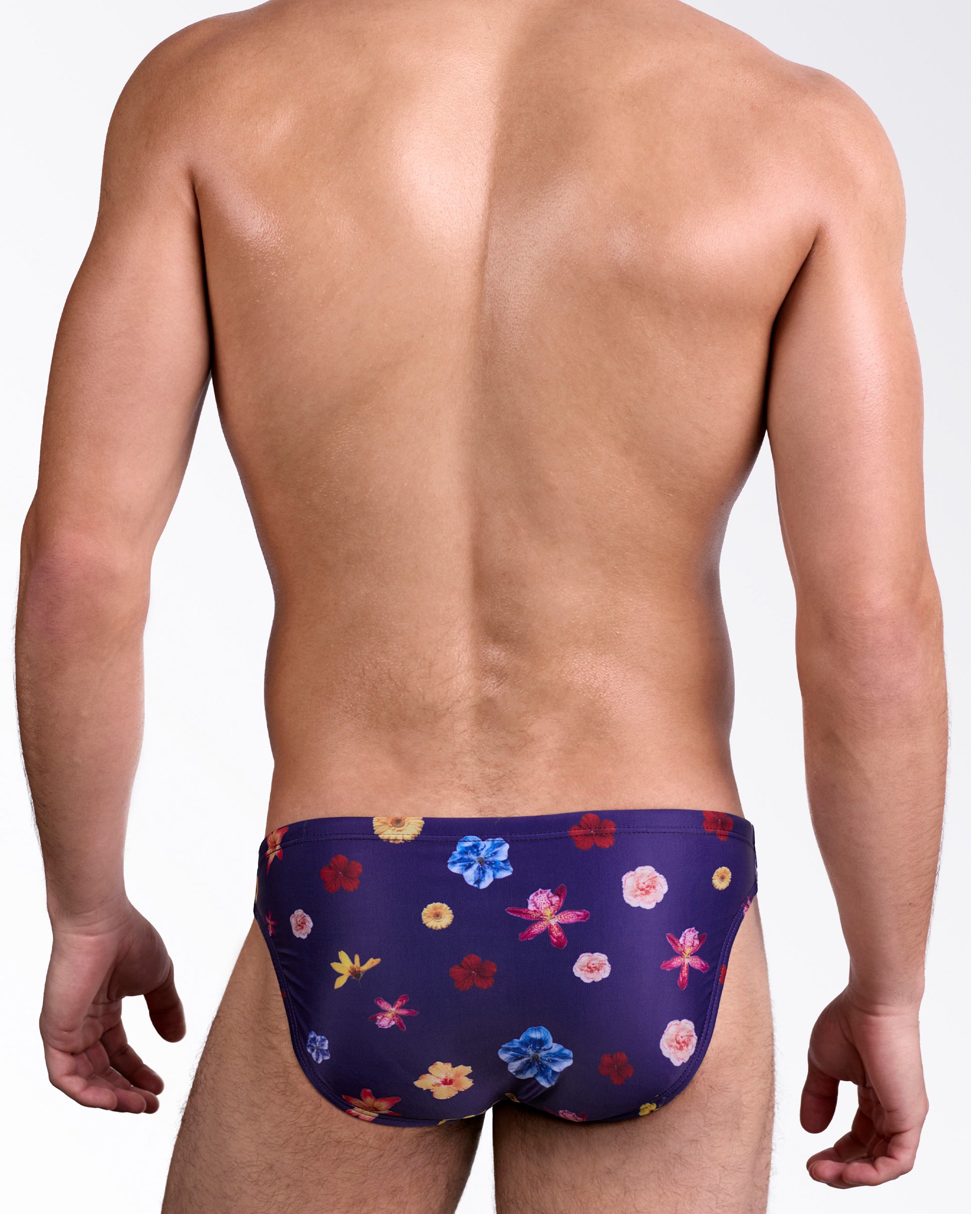 DC2 Flower Powers Blue Swim Mini Brief — back view showing full floral print coverage in navy with vibrant red, pink, and blue flowers.