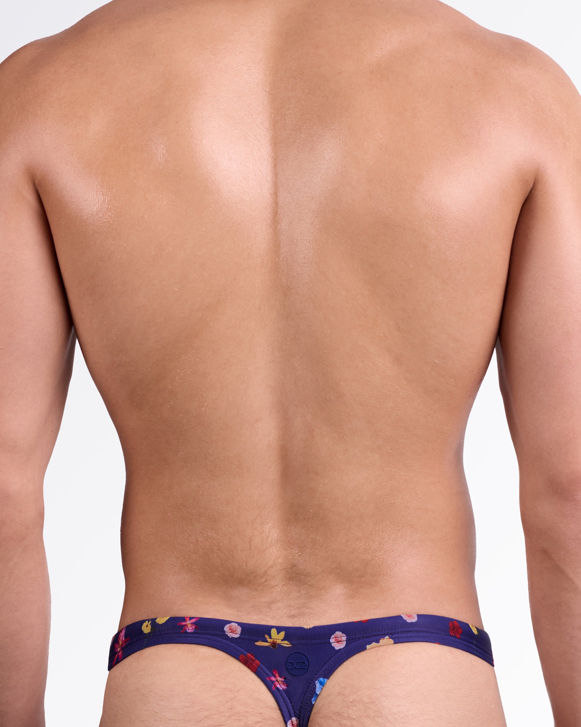 DC2 Flower Powers (Blue) Swim Thong — back view showing sleek thong cut, slim waistband, and all-over bold floral pattern detail.
