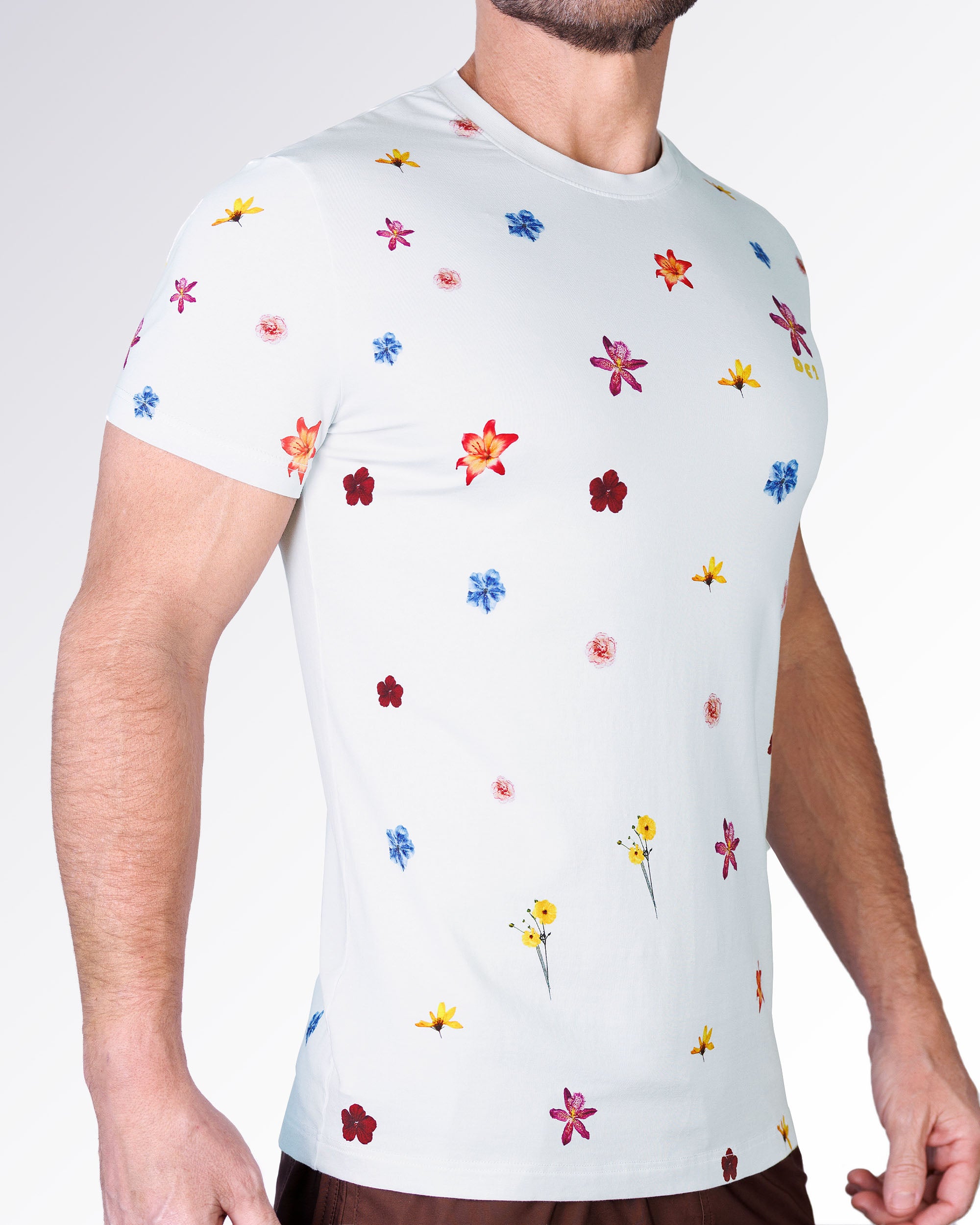 Flower Powers Cream Graphic T-Shirt by DC2 Miami shown from the side, highlighting the all-over floral print with colorful blooms on a cream background.