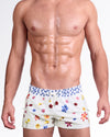 DC2 Flower Powers (Cream) Poolside Shorts — model wearing cream-colored poolside swim shorts featuring a vibrant scattered floral print, adjustable drawstring waistband, and modern short-length beach silhouette.