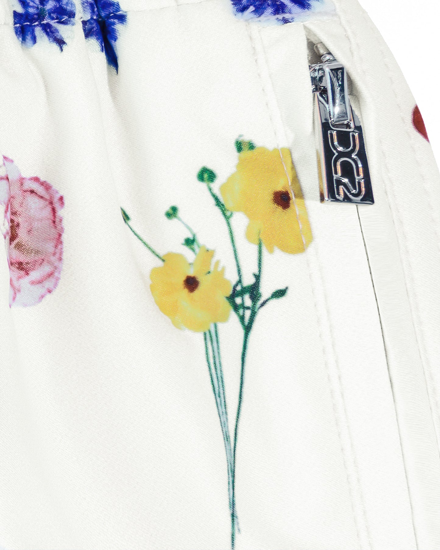 DC2 Flower Powers (Cream) Poolside Shorts — close-up detail of the side zipper pocket with metallic DC2-branded pull tab and floral print fabric.