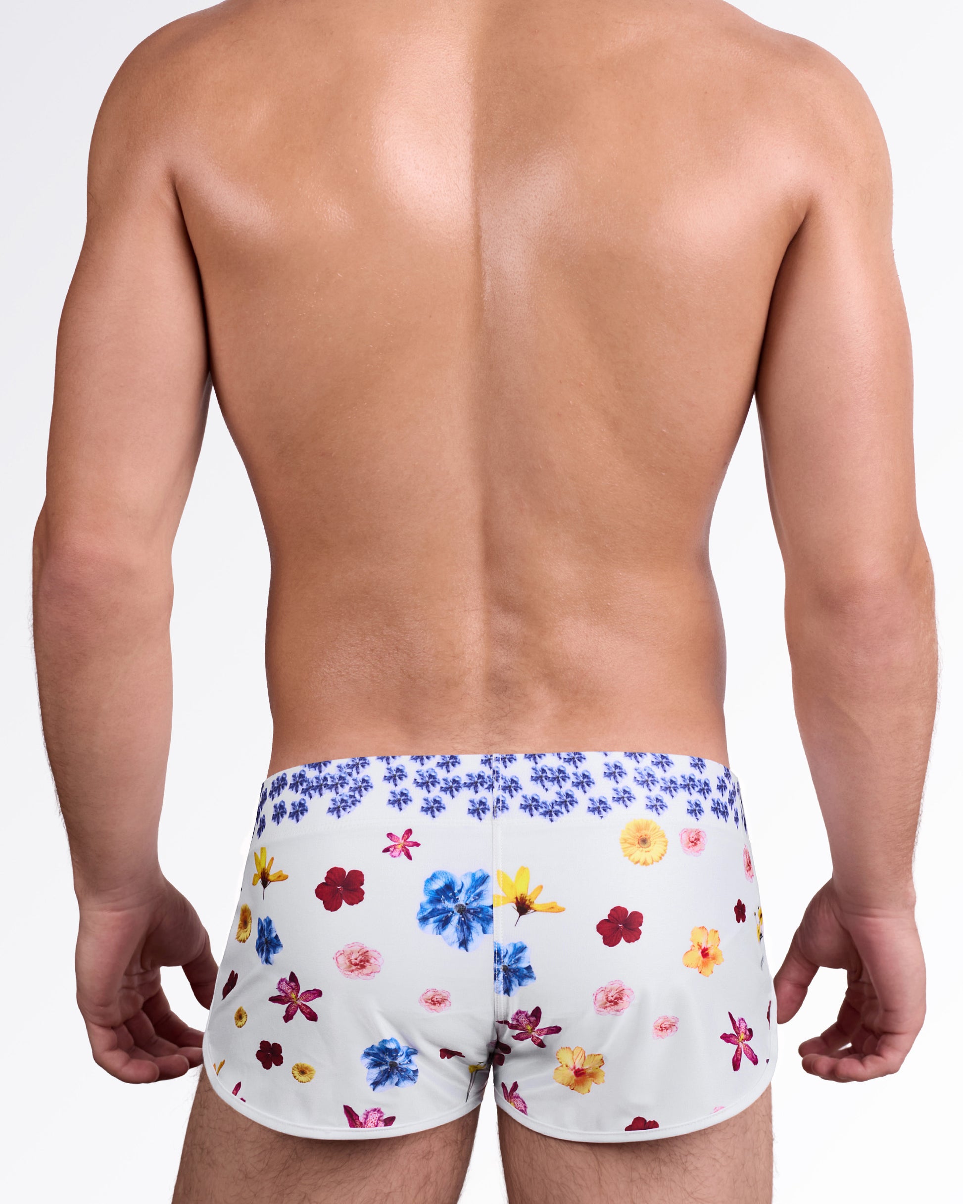 DC2 Flower Powers (Cream) Swim Shorts — back view showing allover vibrant floral placement in red, blue, yellow, and pink tones.