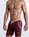 Side view of men’s calisthenics exercise shorts for men in a red color made by BANG! Clothing the official brand of mens sportswear.