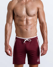 Frontal view of male model wearing the FOCUSED RED athletic crossfit gym shorts in a solid red color by the Bang! brand of men's beachwear from Miami.