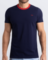 Frontal view of a male model wearing a navy blue Pima cotton t-shirt with a bold red collar, crafted for stylish casual wear and beachwear by DC2 Miami. Premium quality men's streetwear t-shirt, perfect fit for summer fashion.