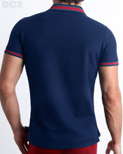 Back View of the FONTAINE BLUE Premium Cotton Polo Shirt for Men in solid dark blue with blue and red stripes on ribbed-knit collar and cuffs. The short-sleeve classic polo shirt is designed by DC2 in Miami.