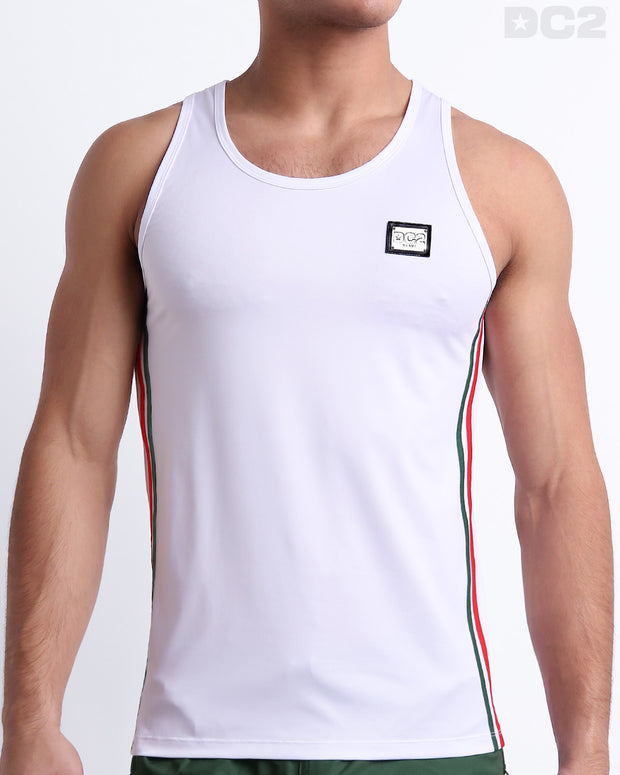 Male model wearing FORZA WHITE men’s casual Tank Top. A premium quality top in a solid white color with red and dark green stripes on the sides, a men’s beachwear brand from Miami.