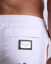 Close-up view of the FORZA WHITE men's Poolside Shorts, showing the zippered back pocket with the DC2 logo in silver, designed by DC2. 
