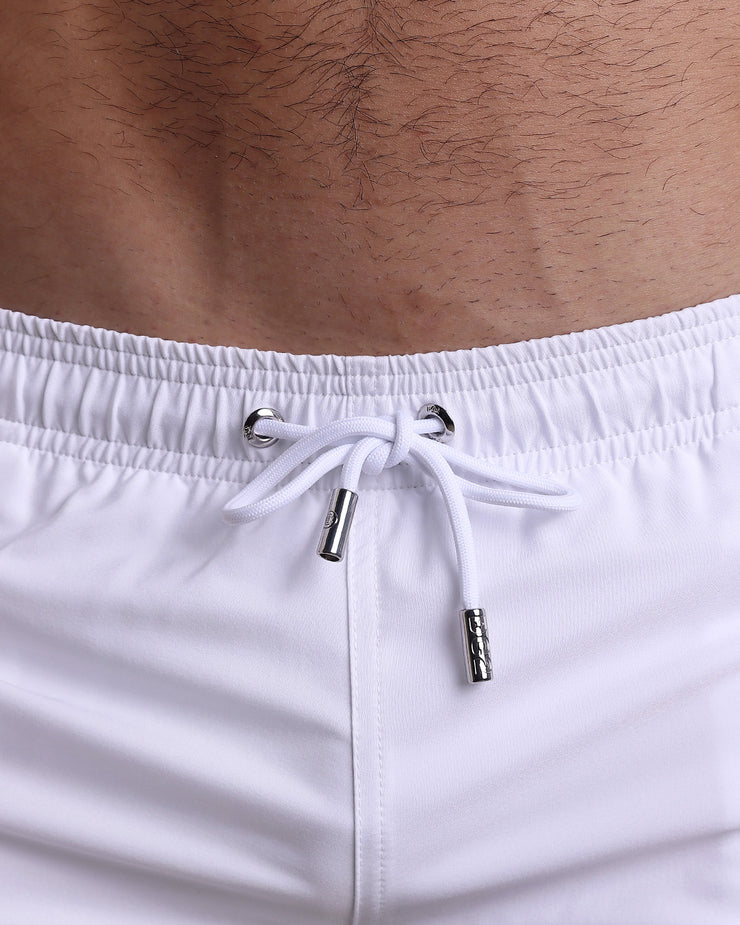 Close-up view of the FORZA WHITE men’s summer shorts, showing white cord with custom branded silver cord ends, and matching custom eyelet trims in silver.