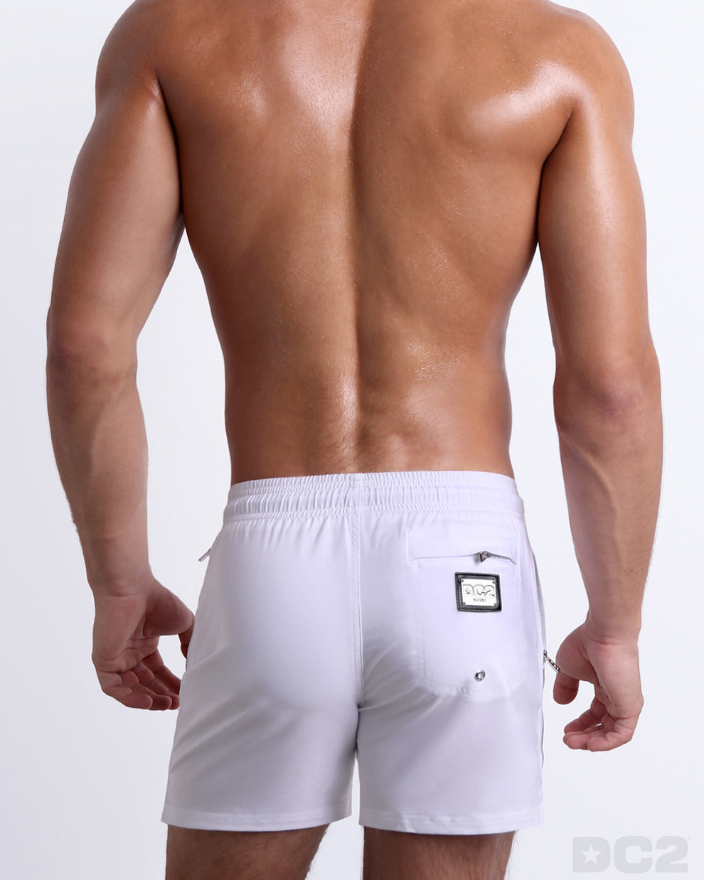 Back view of the FORZA WHITE beach Resort Shorts in a solid white color with green and red side stripes, complete the back pockets, made by DC2 a capsule brand by DC2 Miami.