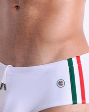 Close-up view of the FORZA WHITE men’s drawstring briefs showing white cord with custom branded metallic silver cord ends, and matching custom eyelet trims in silver.