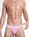 Model wearing the Gently Pink Skin Soft Cotton Modal Thong, featuring a contoured pouch, minimal coverage, and a soft pink BANG! logo waistband.