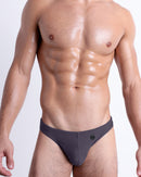 DC2 Gotham Grey Swim Mini Brief — model wearing low-rise men’s swim mini brief with sculpted front pouch and minimal coverage.
