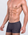 DC2 Gotham Grey — model wearing Gotham Grey Swim Trunks featuring deep charcoal tone and sharp square-cut silhouette.