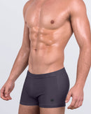 DC2 Gotham Grey — model wearing Gotham Grey Swim Trunks featuring deep charcoal tone and sharp square-cut silhouette.