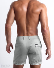 Back view of a model wearing woven twill cotton chino shorts in a light silver grey color for men. These premium quality swimwear bottoms are DC2 by BANG! Clothes, a men’s beachwear brand from Miami.