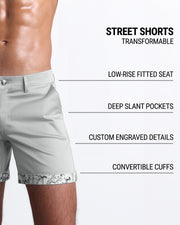 Men tailored fit chino shorts in GREYS JONES by DC2 Keeps you feeling comfortable and looking sharp all. Classic chino shorts for men in a cotton blend from DC2 Clothing from Miami. Features two front pockets and custom engraved button front closure with zip fly. Can roll-up cuffs for shorter length and showing internal print. Or hem down for a mid-thigh length and full-solid grey color showing.