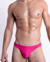 DC2 HOT SHOT MAGENTA — model wearing Hot Shot Magenta Swim Mini Briefs, featuring a bold magenta hue in a sleek, sculpting cut.