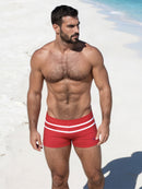 Heated Revelry men’s swimwear inspired by the hit show Heated Rivalry, featuring the red Scott Swim Trunks with hockey-inspired striped details.