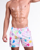 BANG! Miami I SAW THE SIGN Resort Shorts — model wearing men’s white swim shorts with colorful graphic print, featuring elastic waistband with drawstring and relaxed resort fit.