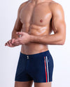 Imperial Blue Beach Shorts featuring a modern fit, flat waistband, contrast side stripes, metallic zip pocket, and built-in brief liner.