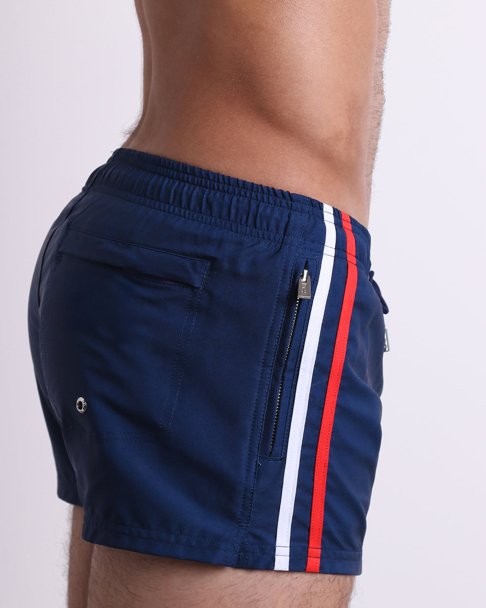 Side close-up of the Imperial Blue Poolside Shorts featuring fully closing zip pockets, contrast side stripes, and water-resistant metallic zippers.