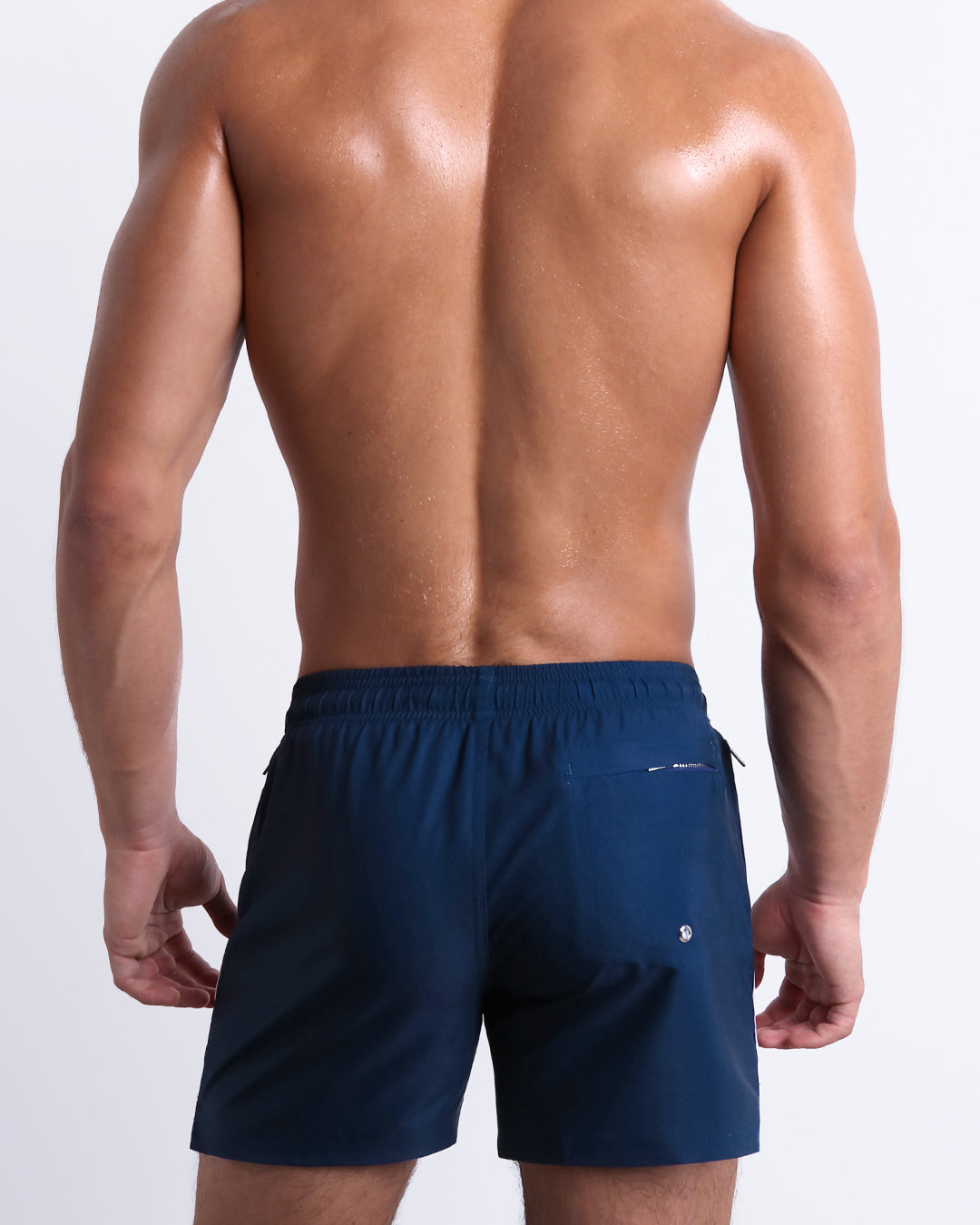 Back view of the Imperial Blue Resort Shorts showcasing the roomy fit, zip back pocket, and clean navy finish with contrast side stripes.