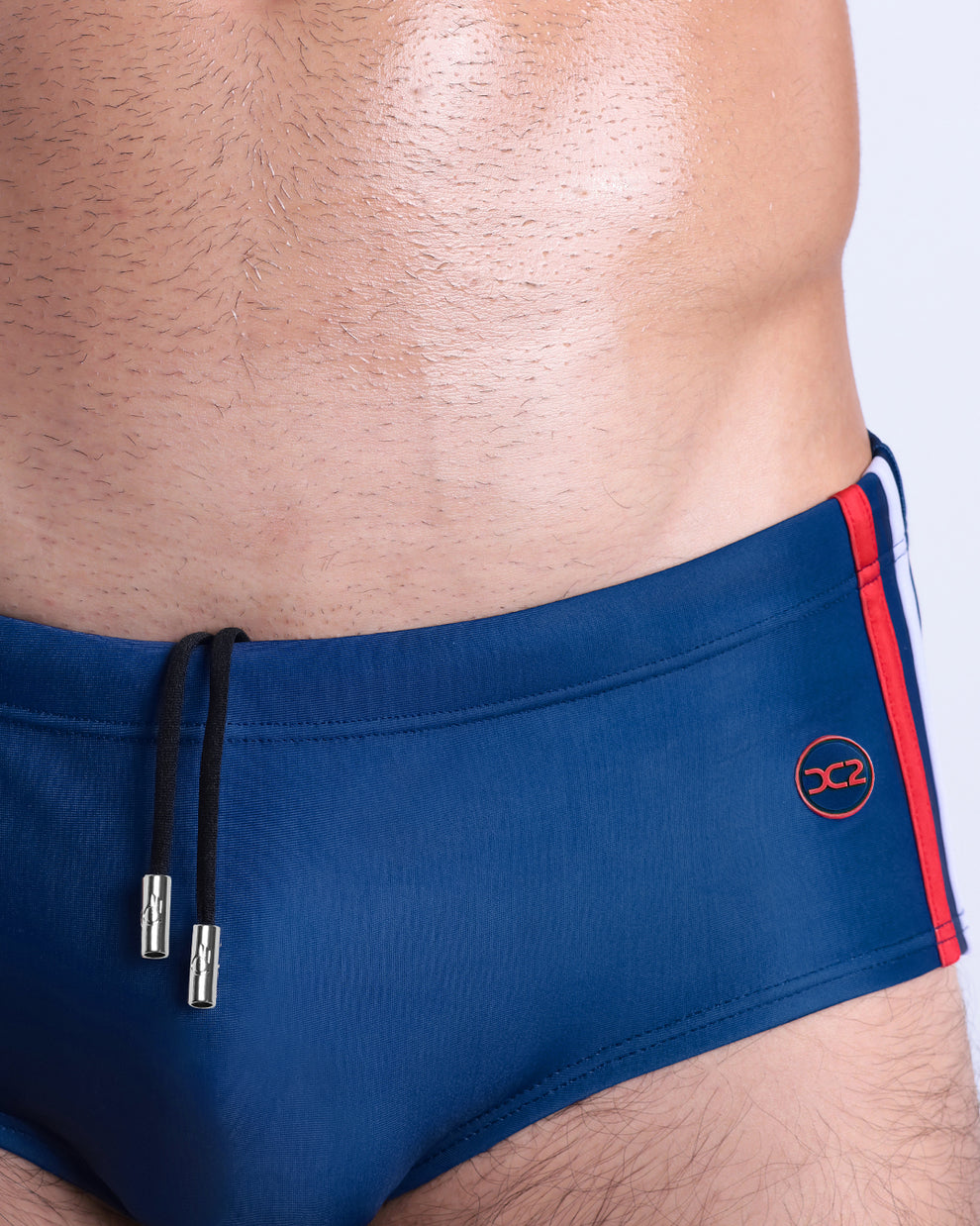 Infographic explaining the Brazilian Men's Swim Sunga remixed by BANG! These Swim Sunga are easy around the waist, are mid-length waist coverage, are tight around the legs, and have contoured-shape pouch.