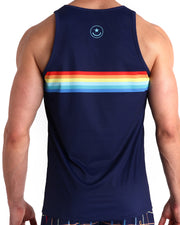 Back view of male model wearing the INFINITY STRIPES summer tank top for men by BANG! Miami in navy blue color featuring multi color red, orange, yellow and blue stripes inspired by by iconic P.L. Rolando's Saleti Settanta Bjorn Borg FILA. 