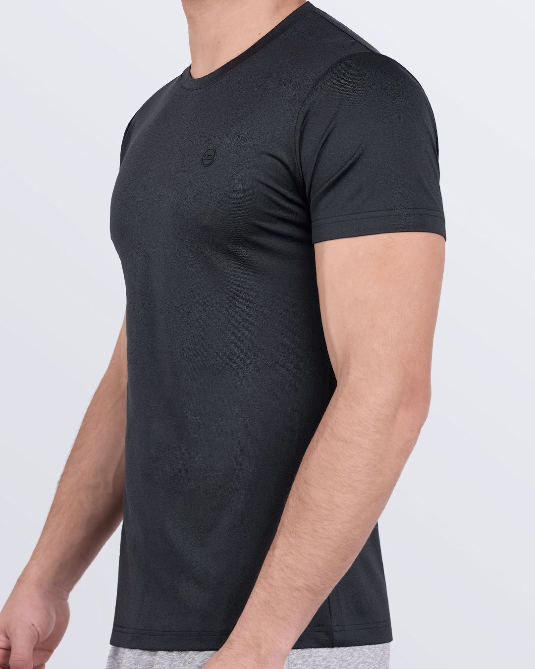 DC2 Iron Black Fitness T-Shirt — side view showing stretch fabric and minimal logo detailing.