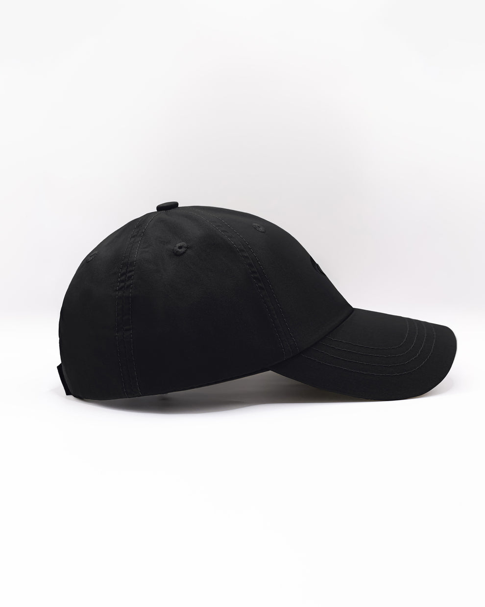 DC2 White Resort Cap — side profile showing curved brim, smooth cotton fabric, and relaxed dad-cap silhouette.