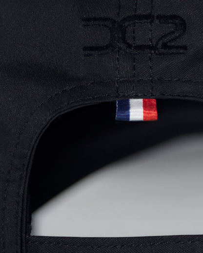 Interior detail of DC2 White Resort Cap — soft cotton lining, adjustable strap, and branded care label.

