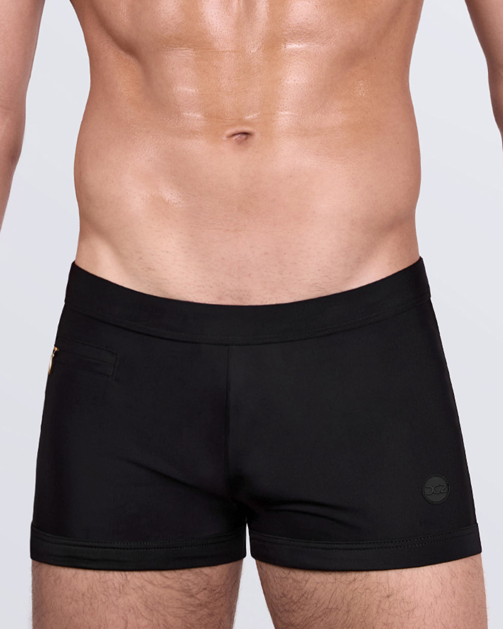 DC2 JET BLACK Swim Trunks — side view highlighting discreet zippered mini pocket and tone-on-tone logo detail.