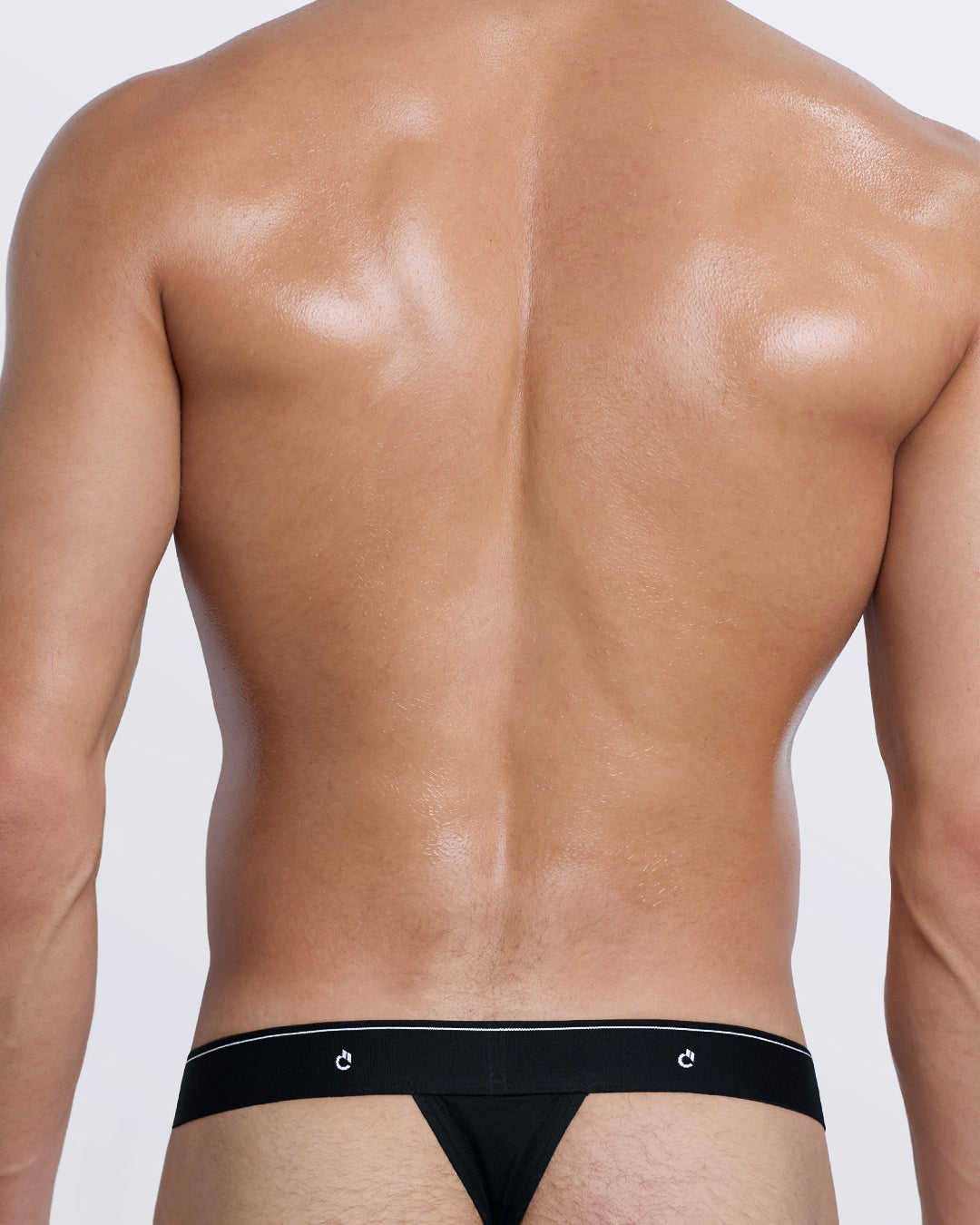 DC2 Modal Thong — back view in black showing minimalist thong cut with logo detail and soft stretch waistband.