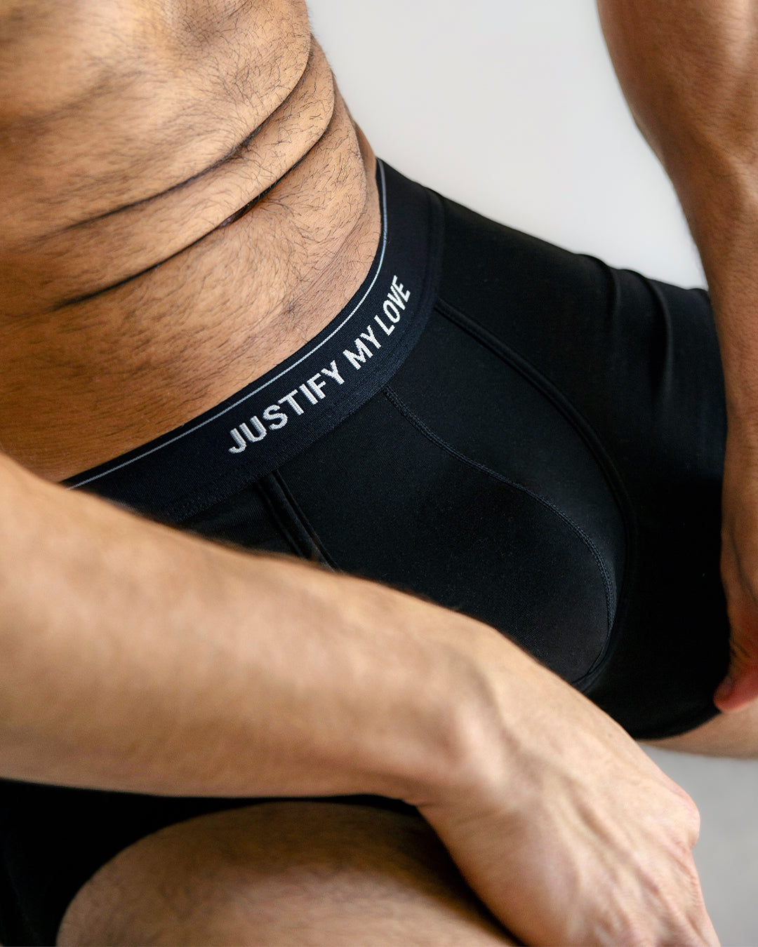 Close-up of BANG! Justify My Love Boxer Brief — featuring soft black modal fabric, contour stitching, and a bold elastic waistband with “JUSTIFY MY LOVE” lettering for a sleek, modern finish.