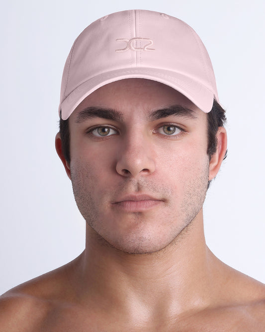 DC2 Resort Cap in Leisure Pink — front view showcasing a curved brim, structured crown, and tonal embroidered DC2 logo.