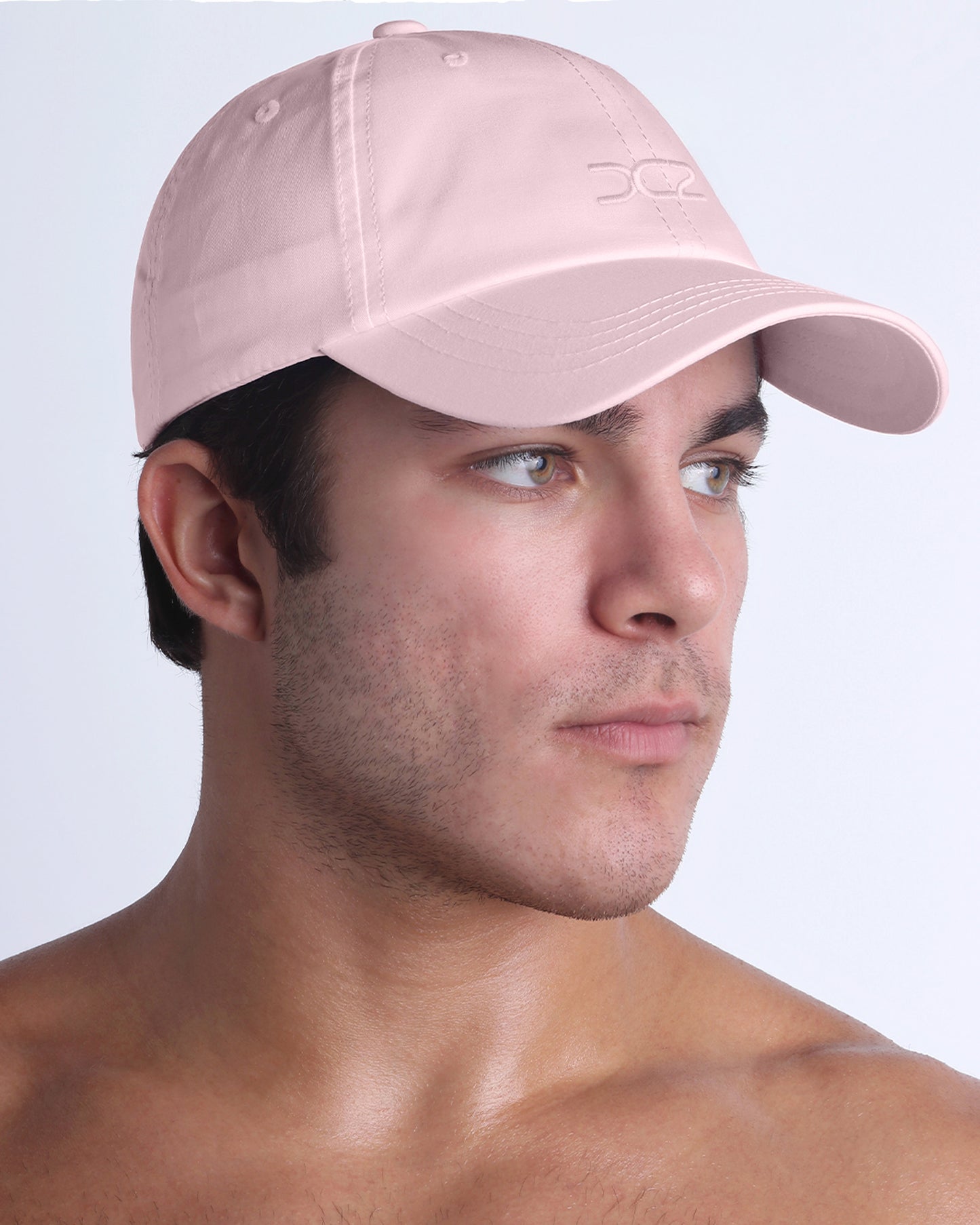 DC2 Leisure Pink Resort Cap — angled view emphasizing the curved brim, clean stitching, and subtle DC2 embroidery.
