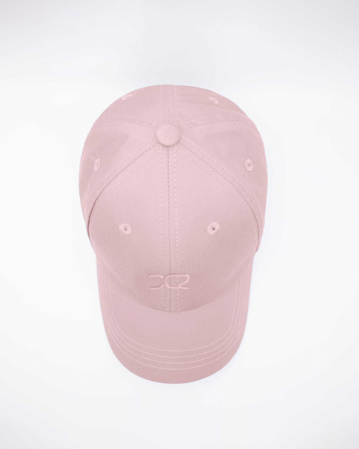 DC2 Leisure Pink Resort Cap — top view highlighting the six-panel construction, stitched seams, and breathable eyelets.