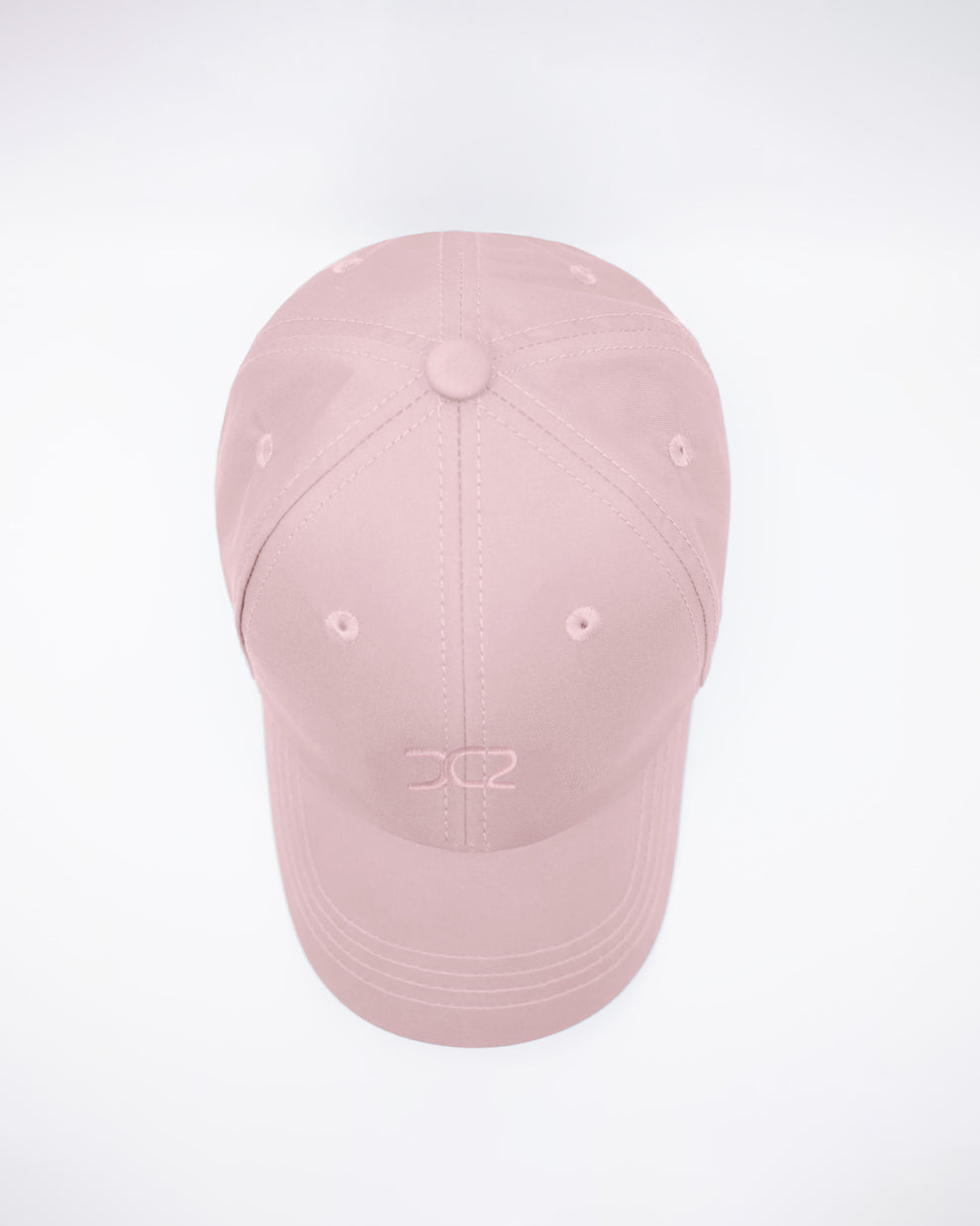 DC2 Leisure Pink Resort Cap — top view highlighting the six-panel construction, stitched seams, and breathable eyelets.