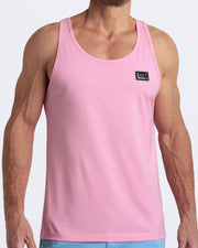 A model wearing the LITERALLY PINK men's fitness breathable tank top with the BREEZY BLUE Street Shorts. The casual beach tank top is made of modal cotton blend in a solid light pastel pink color by DC2 Miami menswear.