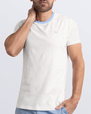 A model wearing the LOTUS WHITE, a white Pima cotton t-shirt with a light blue collar, showcasing the breathable, lightweight fabric ideal for summer beachwear and street style. Part of the DC2 Miami men's casual collection, featuring a perfect fit for active wear